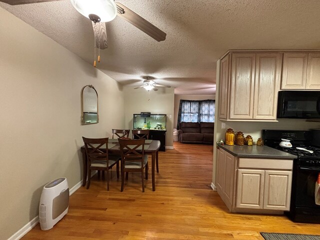 1806 38th St, Snyder, TX 79549 - kitchen with black appliances, ceiling fan, a textured ceiling, light wood-style floors, and dark countertops