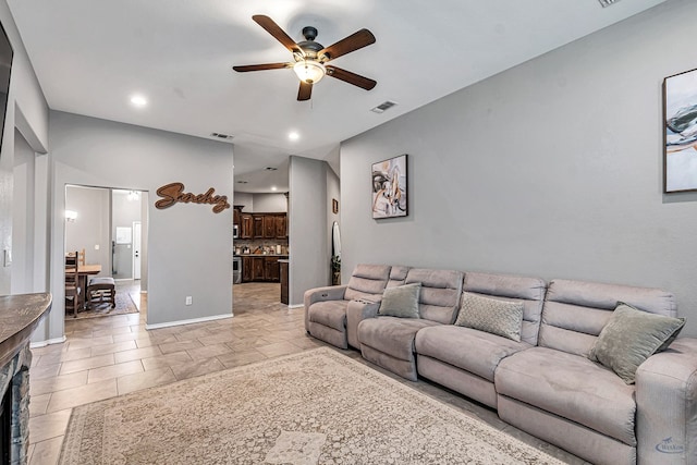 1321 Pine Ave, Midland, TX 79705 - living room featuring a ceiling fan, recessed lighting, and a fireplace