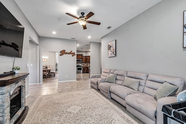 1321 Pine Ave, Midland, TX 79705 - living room featuring a ceiling fan, a fireplace, and recessed lighting