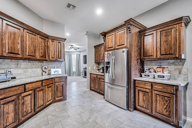 1321 Pine Ave, Midland, TX 79705 - kitchen featuring stainless steel refrigerator with ice dispenser, a ceiling fan, tasteful backsplash, light stone counters, and recessed lighting