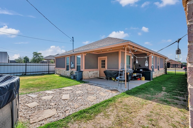 1321 Pine Ave, Midland, TX 79705 - rear view of house with a fenced backyard, a patio area, a shingled roof, and stone siding