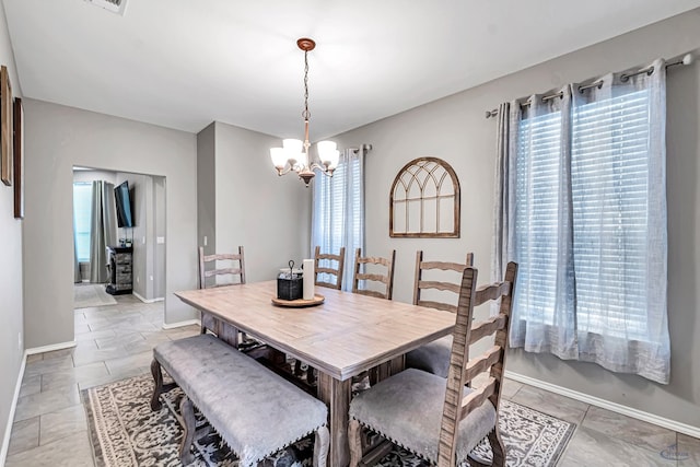 1321 Pine Ave, Midland, TX 79705 - dining space featuring a chandelier and healthy amount of natural light