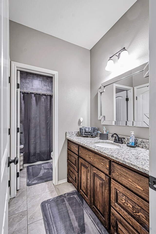 1321 Pine Ave, Midland, TX 79705 - bathroom with vanity and a shower with curtain