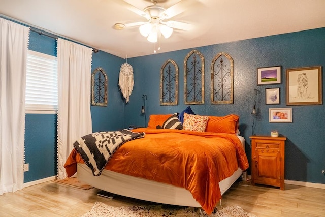 bedroom featuring light hardwood / wood-style flooring and ceiling fan