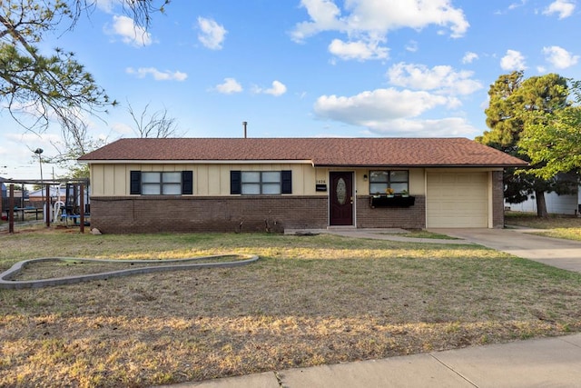 2826 Beechwood St, Odessa, TX 79761 - ranch-style home featuring brick siding, an attached garage, board and batten siding, a front lawn, and concrete driveway