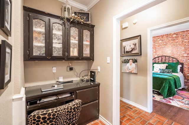 bar with dark brown cabinets and ornamental molding