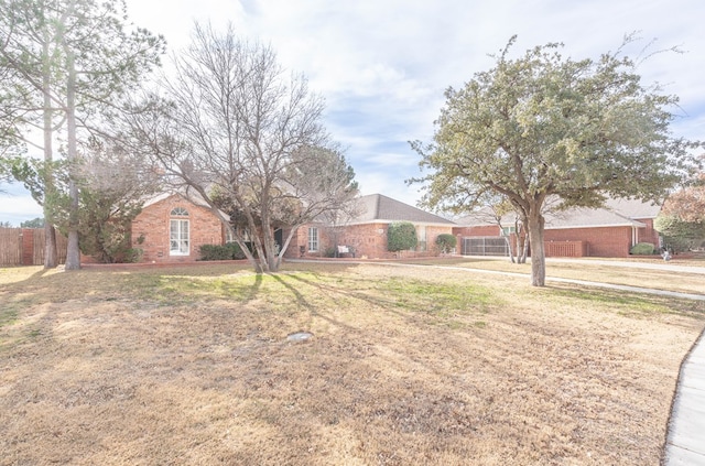 ranch-style home with a front lawn