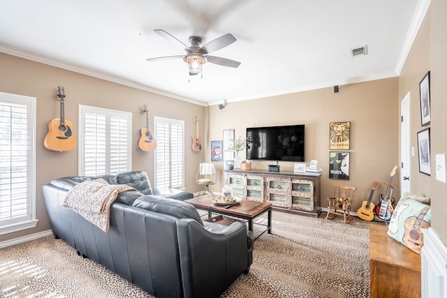 living room featuring carpet, ceiling fan, ornamental molding, and a wealth of natural light