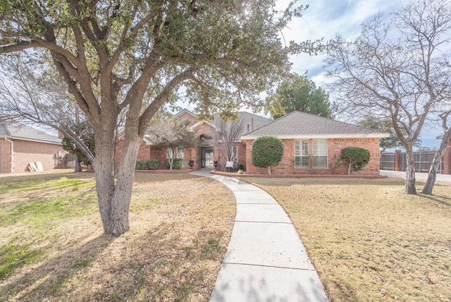 ranch-style home with a front lawn