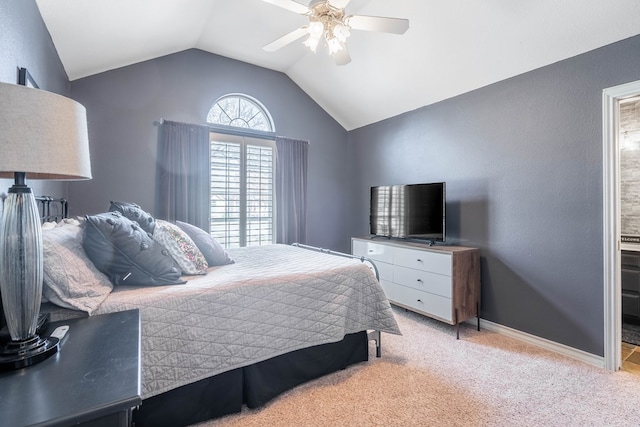 carpeted bedroom with ceiling fan, ensuite bathroom, and lofted ceiling