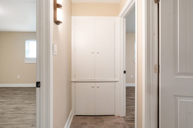 hallway with light hardwood / wood-style floors