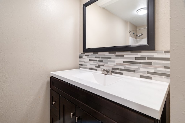 bathroom with decorative backsplash and vanity