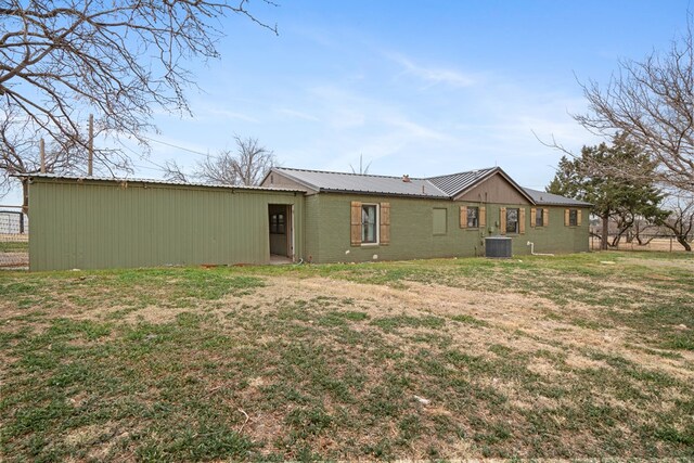 rear view of house featuring a yard and cooling unit