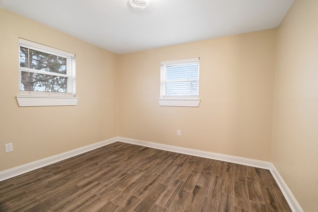 empty room with dark hardwood / wood-style floors