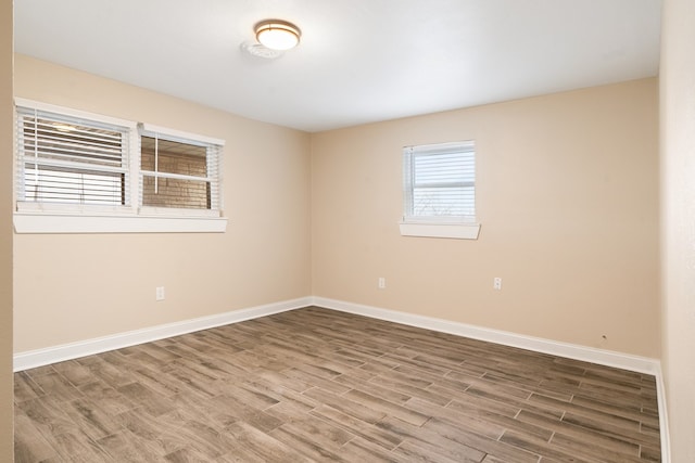 unfurnished room with wood-type flooring