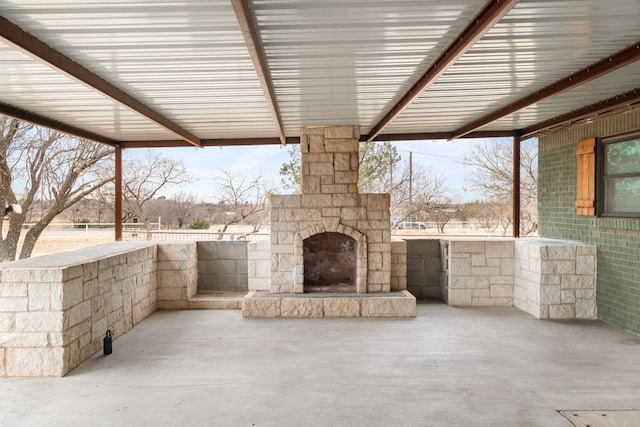 view of patio / terrace featuring an outdoor stone fireplace