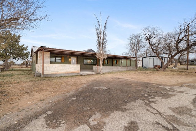 view of front of house featuring a storage shed