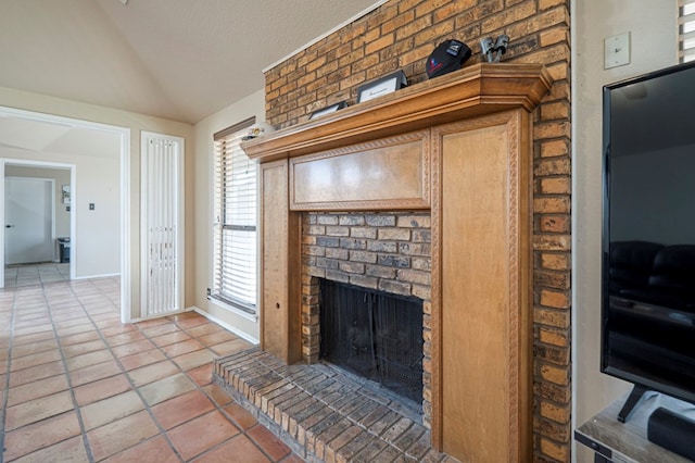 living room featuring a fireplace, lofted ceiling, light tile patterned flooring, a textured ceiling, and baseboards