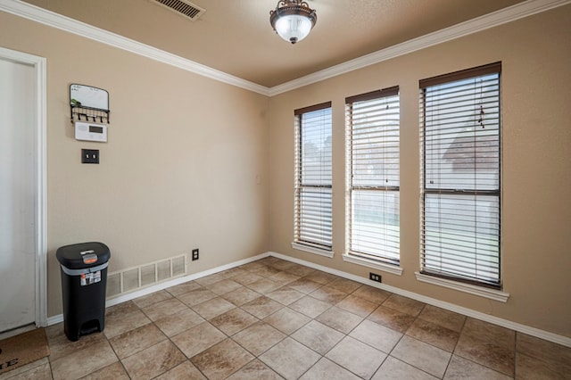 unfurnished room with ornamental molding, visible vents, and baseboards