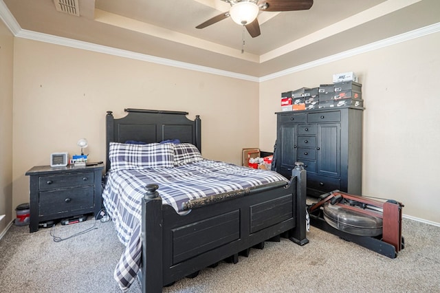 bedroom featuring carpet floors, a tray ceiling, visible vents, and crown molding