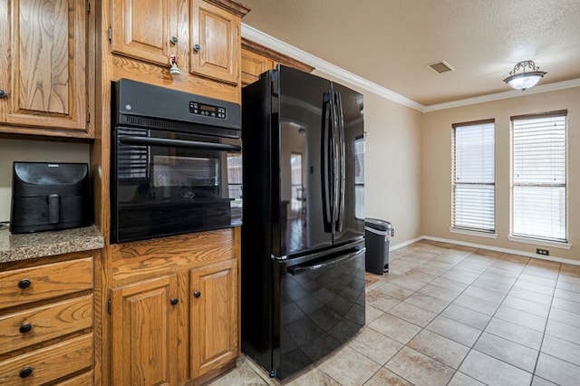 kitchen featuring light tile patterned floors, a textured ceiling, visible vents, black appliances, and crown molding