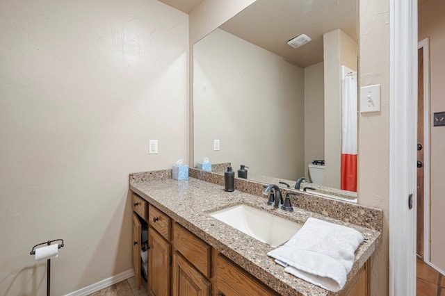 bathroom featuring toilet, baseboards, visible vents, and vanity