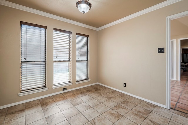 spare room with a wealth of natural light, crown molding, and light tile patterned floors