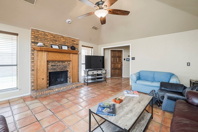 living area featuring ceiling fan, light tile patterned flooring, a fireplace, and visible vents