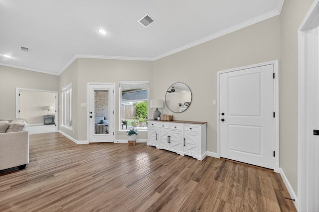 6113 Turtle Creek Rd, Midland, TX 79707 - entrance foyer with crown molding, light wood finished floors, and recessed lighting