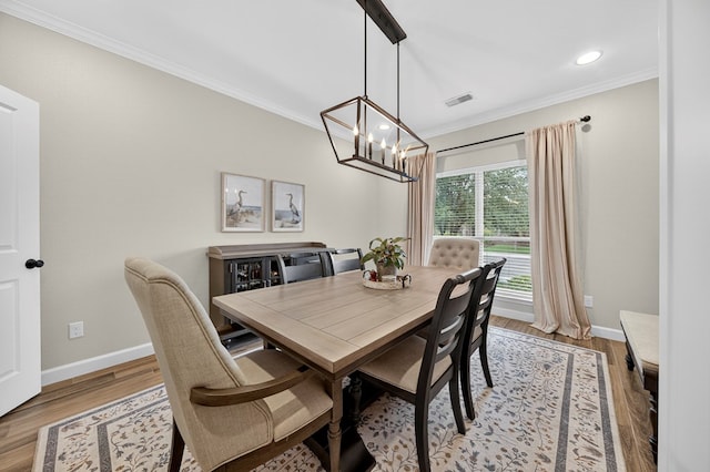 6113 Turtle Creek Rd, Midland, TX 79707 - dining space featuring crown molding, light wood-style flooring, a chandelier, and recessed lighting