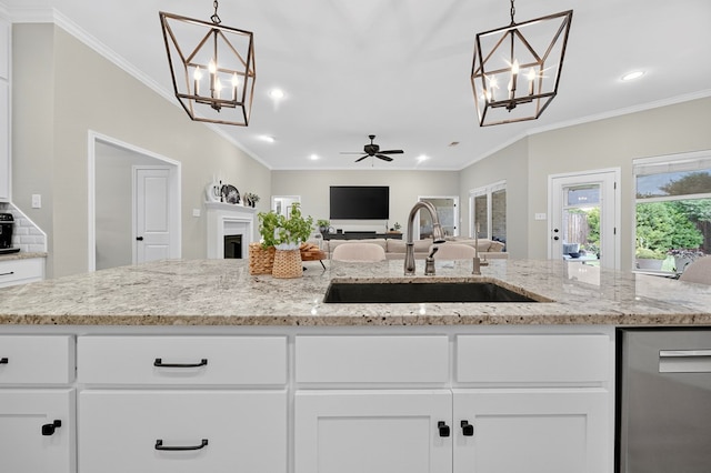 6113 Turtle Creek Rd, Midland, TX 79707 - kitchen featuring a chandelier, stainless steel dishwasher, open floor plan, recessed lighting, and white cabinetry