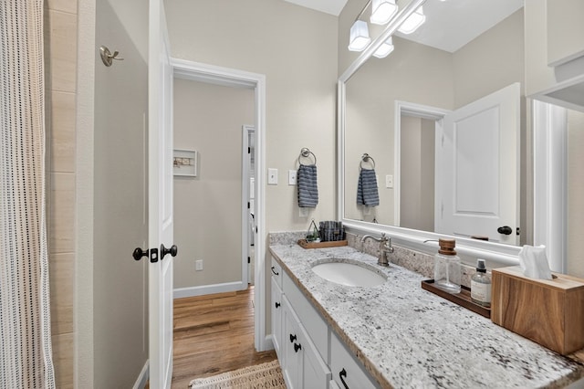 6113 Turtle Creek Rd, Midland, TX 79707 - full bath with vanity, wood finished floors, and a shower with shower curtain