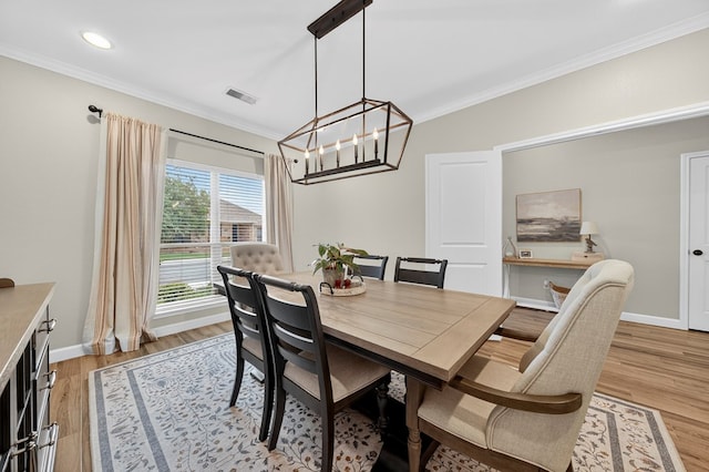 6113 Turtle Creek Rd, Midland, TX 79707 - dining space featuring crown molding, light wood-style floors, a chandelier, and recessed lighting