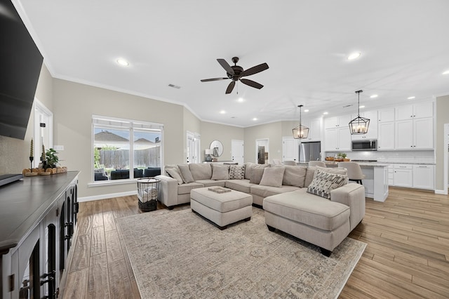 6113 Turtle Creek Rd, Midland, TX 79707 - living room with recessed lighting, ceiling fan, light wood finished floors, and crown molding