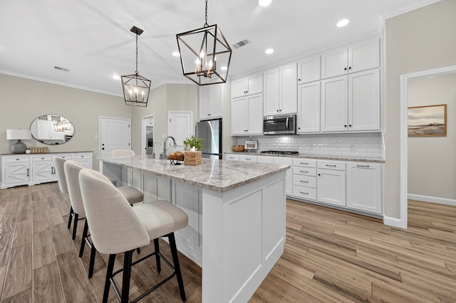 6113 Turtle Creek Rd, Midland, TX 79707 - kitchen featuring a chandelier, decorative backsplash, white cabinets, crown molding, and a kitchen breakfast bar