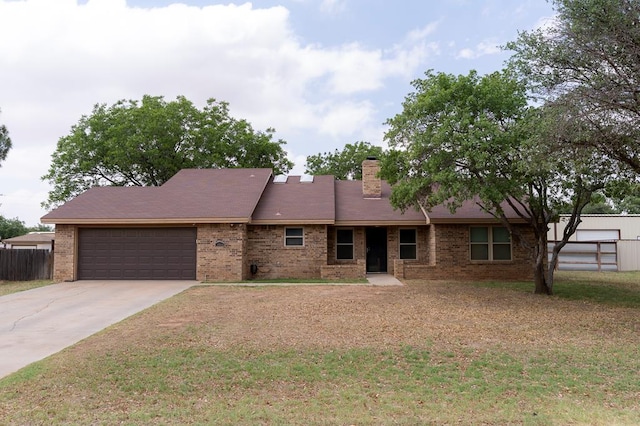 10905 E County Rd 107, Midland, TX 79706 - ranch-style house featuring a garage, brick siding, concrete driveway, and a chimney