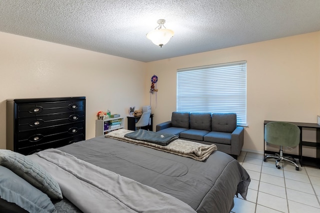 10905 E County Rd 107, Midland, TX 79706 - bedroom with light tile patterned flooring and a textured ceiling