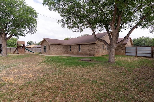 10905 E County Rd 107, Midland, TX 79706 - rear view of property featuring a playground and brick siding
