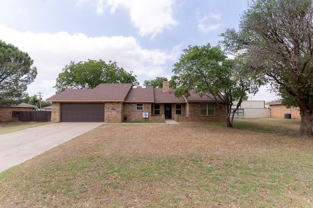 10905 E County Rd 107, Midland, TX 79706 - single story home with an attached garage, concrete driveway, brick siding, and a chimney