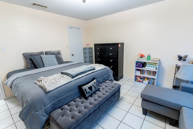 10905 E County Rd 107, Midland, TX 79706 - tiled bedroom featuring a textured ceiling