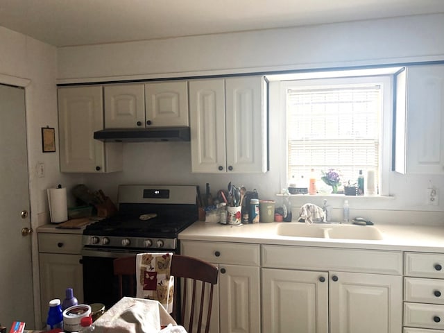 1122 E Cowden Ave, Midland, TX 79701 - kitchen featuring stainless steel gas range, under cabinet range hood, a sink, and white cabinetry