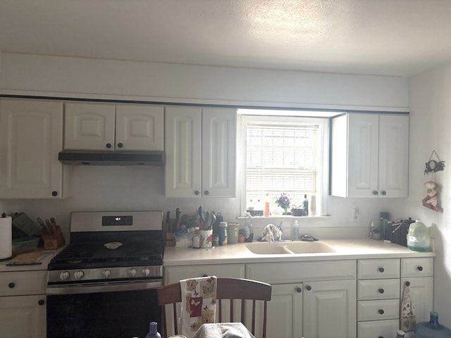 1122 E Cowden Ave, Midland, TX 79701 - kitchen featuring gas range, under cabinet range hood, a sink, and white cabinets