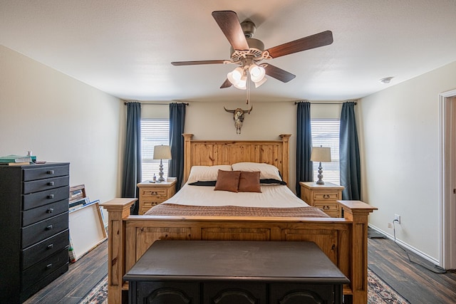 bedroom featuring dark wood-style floors, multiple windows, baseboards, and ceiling fan