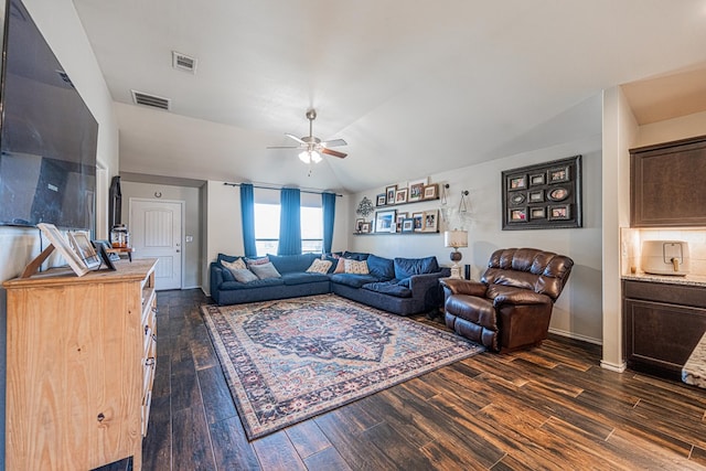 living room with vaulted ceiling, visible vents, ceiling fan, and dark wood-style flooring