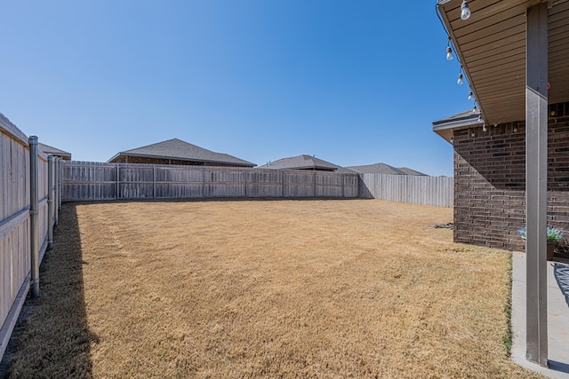 view of yard with a fenced backyard