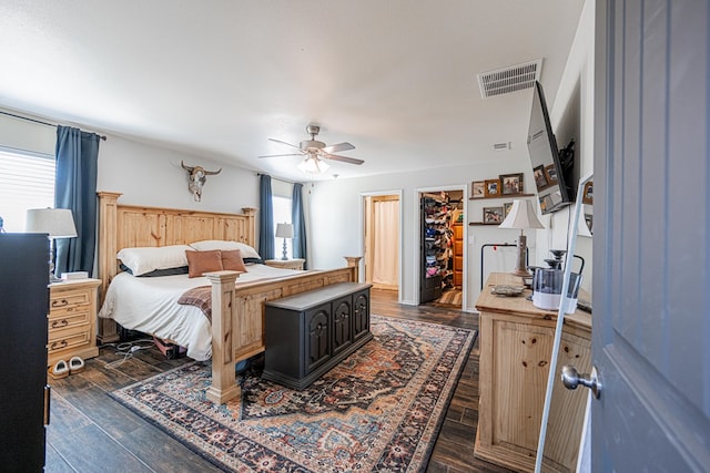 bedroom with dark wood-style floors, visible vents, and a ceiling fan