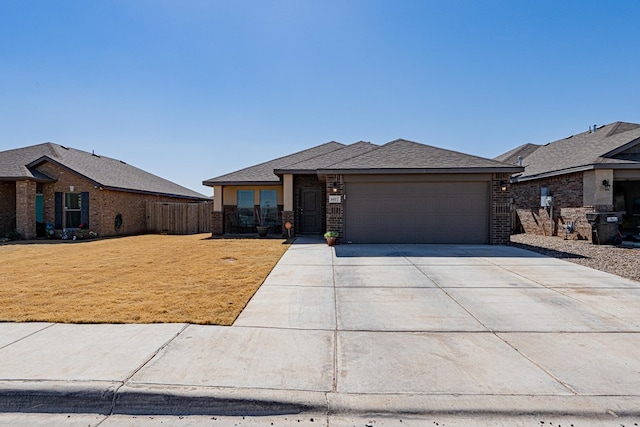 view of front of home featuring fence, driveway, a front lawn, a garage, and brick siding