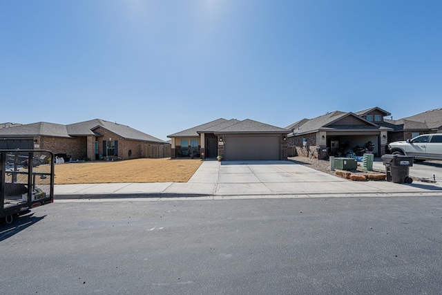 view of front of house featuring an attached garage, concrete driveway, a front yard, and fence