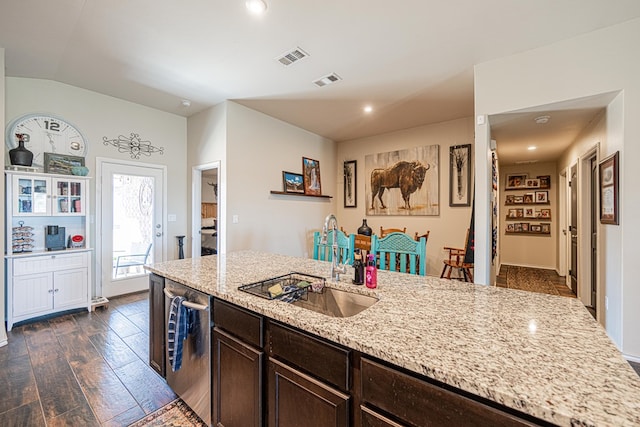 kitchen with visible vents, dark brown cabinets, dark wood-type flooring, dishwasher, and a sink