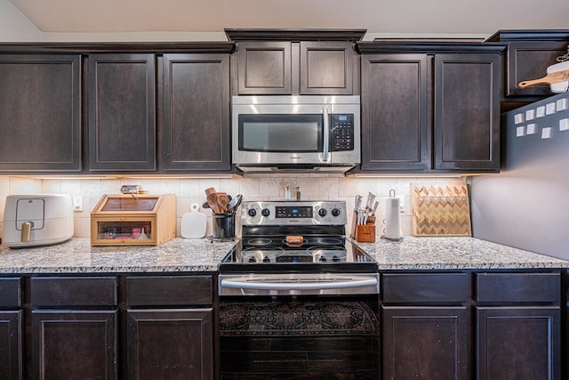 kitchen featuring backsplash, appliances with stainless steel finishes, and dark brown cabinets